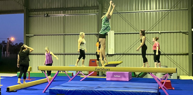 Adult gymnastics class on beams